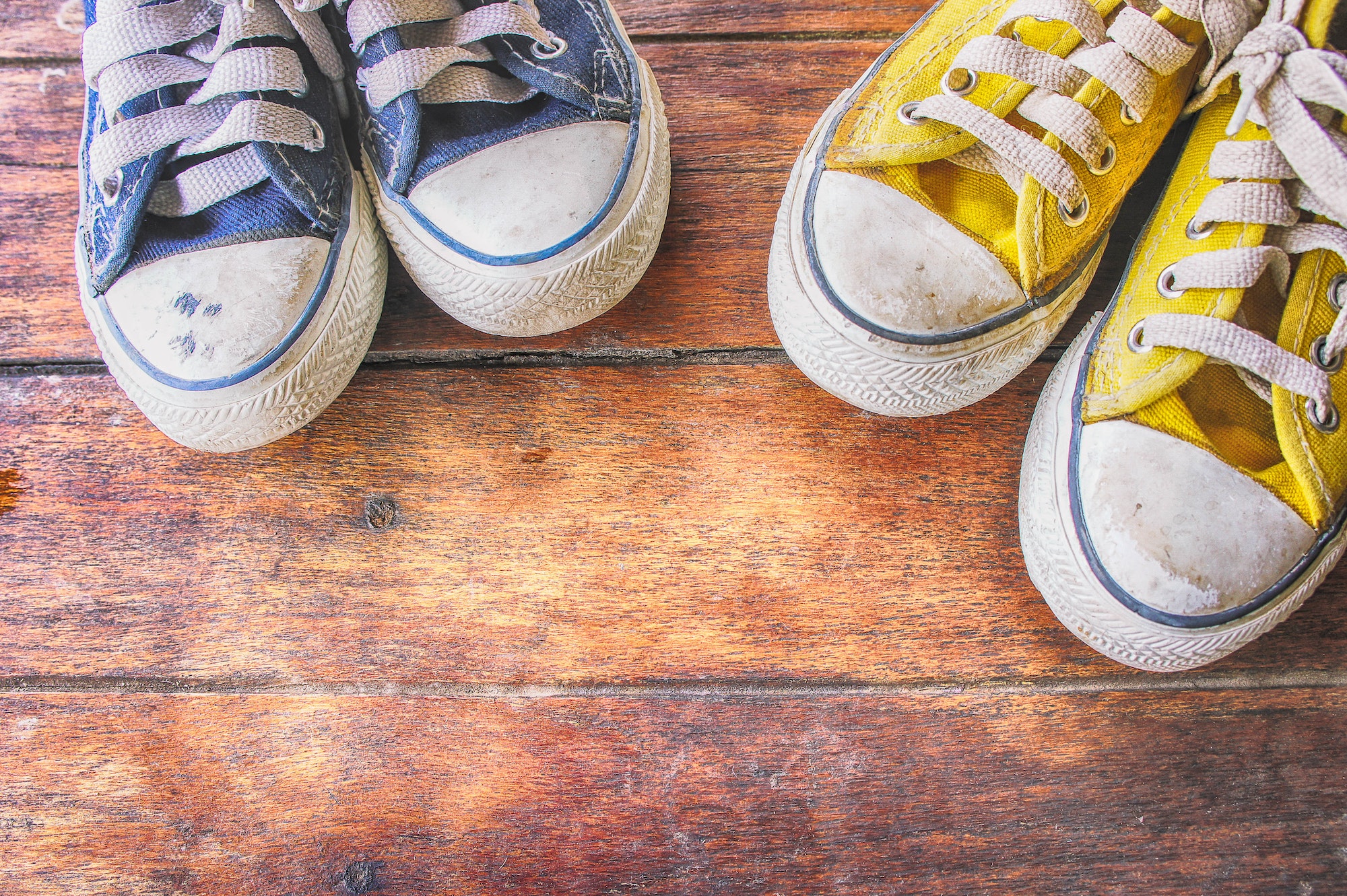 Sneakers on wooden floor , dirty convas shoe on old wood