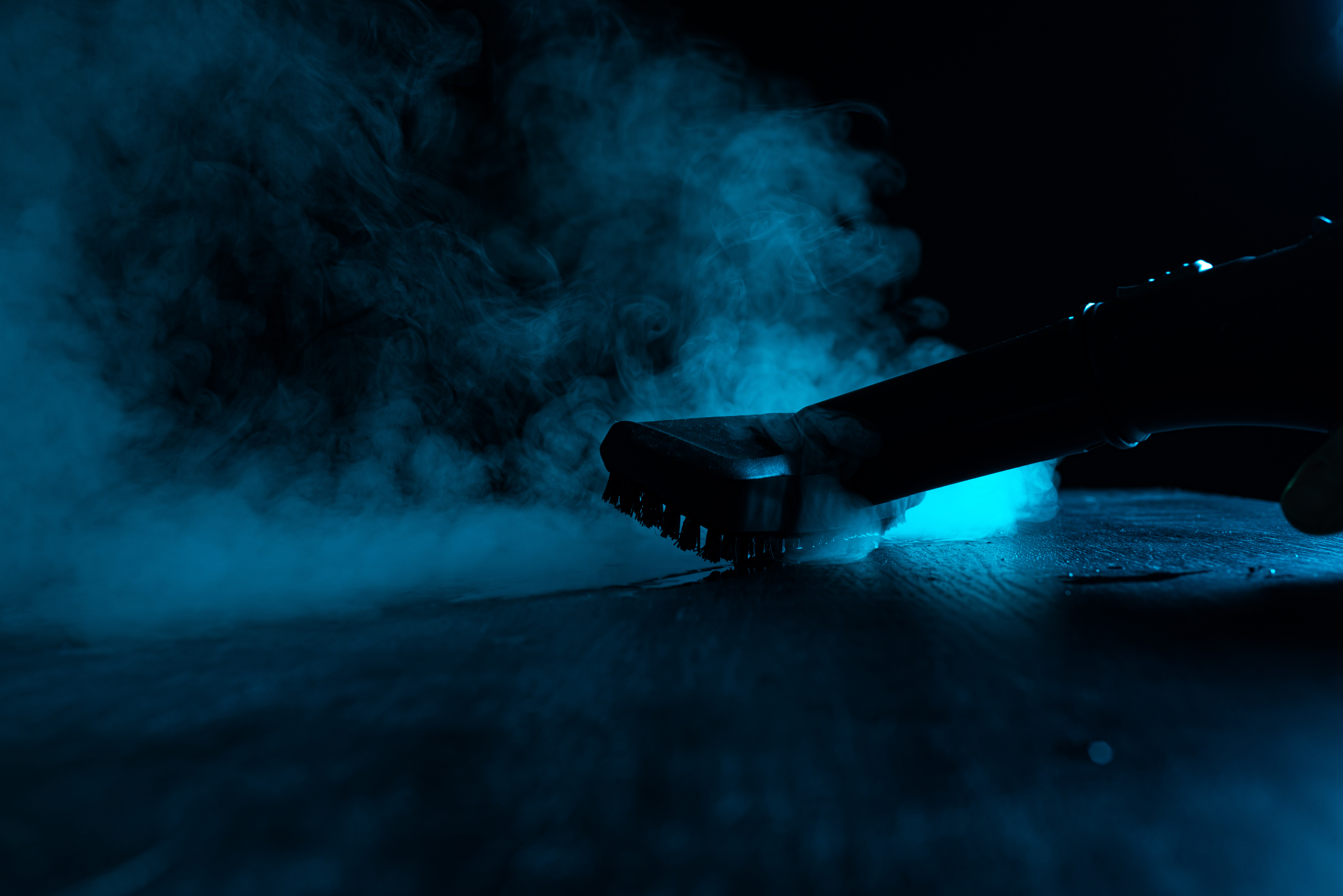 Disinfection with a steam cleaner. Steam on a black background