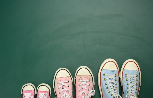 Many multi-colored well-worn textile sneakers of different sizes